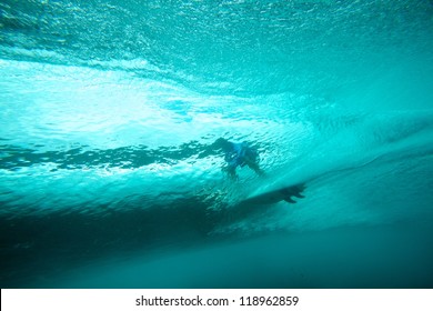 Underwater view of surfer and crystal clear wave