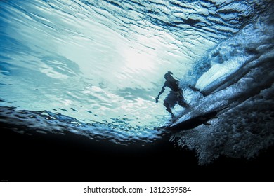 Underwater view of surfer riding wave