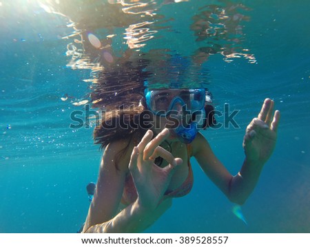 Underwater view of a woman snorkeling in the tropical sea