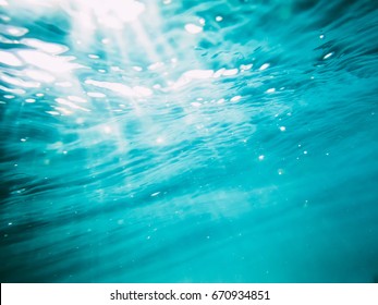 Underwater Wave In Tropical Sea And Sun Rays. Water Texture In Ocean