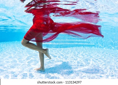 Underwater woman fashion portrait with red veil in swimming pool. - Powered by Shutterstock