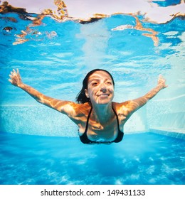 Underwater Woman Portrait Wearing Black Bikini In Swimming Pool.