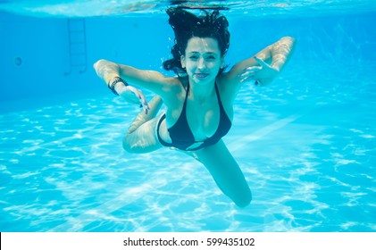 Underwater Woman Portrait Wearing Black Swimsuit In Swimming Pool, Beautiful Turquoise Water. Close-up