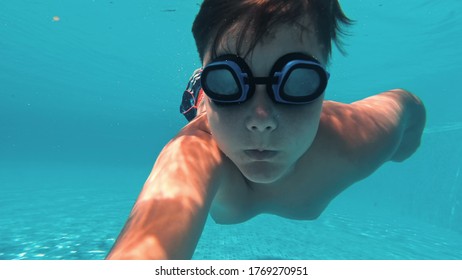 Underwater Young Boy Fun in the Swimming Pool. Summer Vacation Fun.