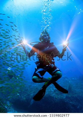 Similar – Man in his back with scuba diving equipment exploring the ocean floor.