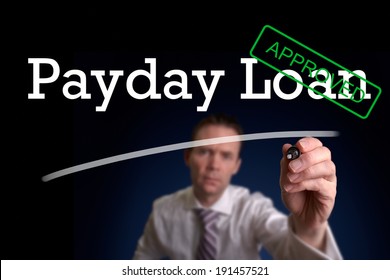 An underwriter writing Payday Loan approved on a screen.