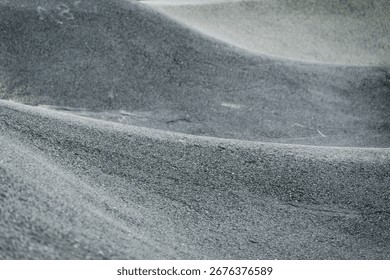 Undulating asphalt structure of the pumptrack, asphalted hills and depressions prepared for skating sports
