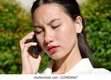 Unemotional Pretty Filipina Person With Cell Phone