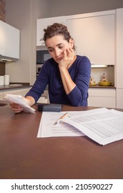 Unemployed And Divorced Woman With Many Debts Reviewing Her Monthly Bills