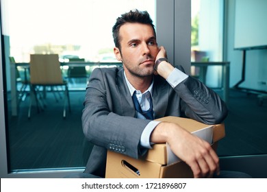 Unemployed fired from job businessman sitting at office floor thinking about his future