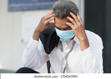 Unemployed Man,Desperate Businessman Sitting Hopelessly On Stair In Central Business District Due To Unemployment From The COVID 19 Disease Situation,Coronavirus Has Turned Into A Global Emergency.