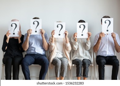 Unemployed Professional Business People Candidates Group Sit On Chairs In Row Line Queue Holding Sheets With Question Mark Hiding Face Waiting For Job Interview, Human Resources And Recruit Concept