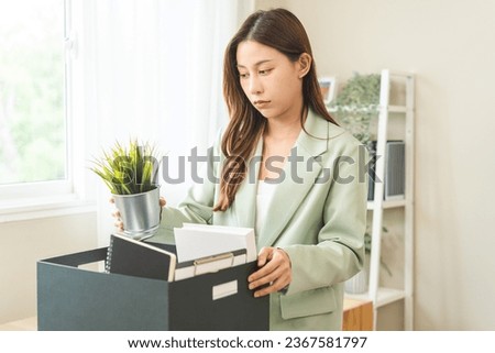 Unemployed, quite job, desperate asian young businesswoman resigning from company packing belongings, stuff in box cardboard, layoff or leaving, changing work. Resignation employment, dismiss concept