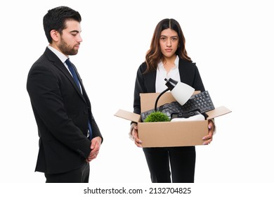 I Am Unemployed. Sad Boss And Business Man Firing A Sales Representative From Work. Tired Young Woman Carrying Her Office Supplies 