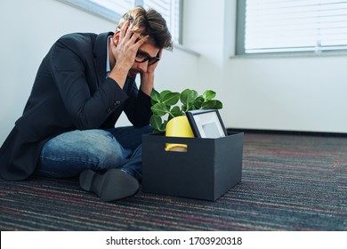 Unemployment, Bankruptcy Concept. Young Businessman Sitting On The Floor In Empty Office.