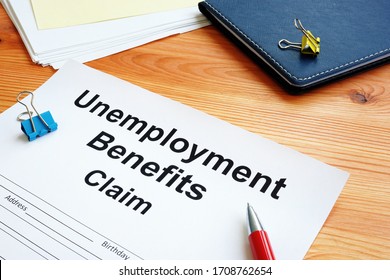 Unemployment Benefits Claim And Stack Of Documents.