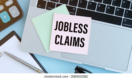 Unemployment Claim Form On White Background Top View Copy SpaceUnemployment Claim Form Written Text Jobless Claims On A Sheet Of Paper On A Laptop.