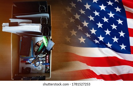 Unemployment USA. Box With Personal Belongings Next To Flag Of America. Corton Box Symbolizes Unemployment. Labor Market Problems In United States Of America. Losing Work By Americans. Dismissal USA