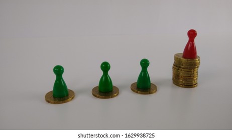 Unequal Wealth Distribution -Coins Were Stacked. The Figure With The Highest Value Has A Different Color 