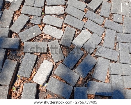 Uneven Cobblestone Pavement With Loose Bricks and Gaps on Urban Sidewalk