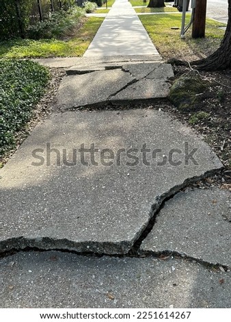 uneven concrete ahead is broken and uneven with trip hazards