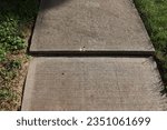 uneven concrete sidewalk with shadow