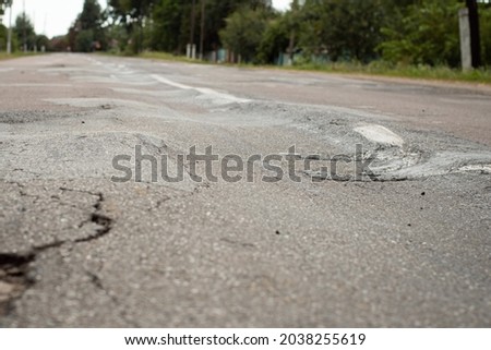 Uneven surface of road after very heavy trucks driving. Ignorant driving, poor quality of asphalt roads concept