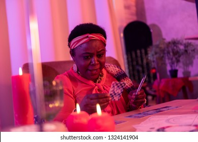 Unexpected Outcome. African American Plump Fortune-teller Wearing Huge Earrings Looking Surprised While Making A Prediction