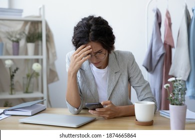 Unexpected problems. Concerned young woman self employed florist getting email with bad news about debt bankruptcy. Female tailor owner of make and mend service stressed after losing customer order