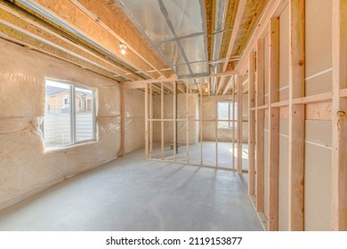 Unfinished basement with wood framing and insulated walls - Shutterstock ID 2119153877