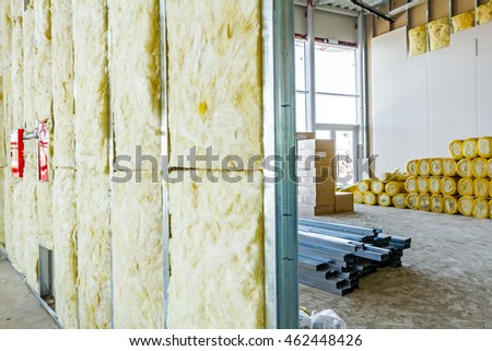 Unfinished building interior, heat isolation wall project with mineral wool is in progress.