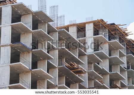 Unfinished cement building at a construction site in the summer