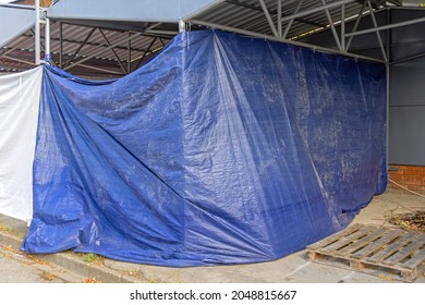 Unfinished Construction Work Covered With Blue Tarp Cover