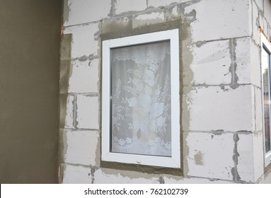 Unfinished house plastering wall with fiberglass mesh, plaster mesh, rigid foam insulation, stucco, window insulation. 