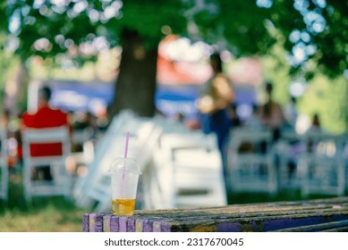 An unfinished lemonade stands on a chair in a summer cinema - Powered by Shutterstock