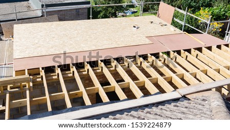 Unfinished roof structure on residential building, view from the top of the scaffold, selective focus