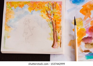 Unfinished Watercolor Painting Of Little Girl In Autumn Landscape With Brush And Palette 