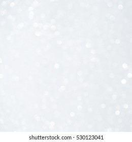 Unfocused abstract white glitter bokeh holiday background. Winter xmas holidays. Christmas