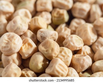 Unfocused Dry Pea Grains In Close-up - An Abstract Food Background. Macrophotography Of Light Yellow Peas With A Small Depth Of Field In The Center. Dried Peas Organic Protein Nutrition.