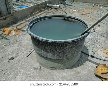 Unfocused Image Of Circle Heavy Duty Black Plastic With Rain Water And Dirty Water In It. Old Rusty Water Tank.