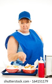 Unfriendly, No-nonsense Cashier At A Fast Food Restaurant, Serving Your Order.  Isolated On White.  