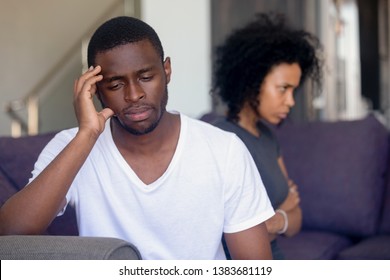 Unhappy African American husband and wife sit aside avoid talking after fight, thoughtful black man think about relationships problems or separation, young couple consider breakup after quarrel