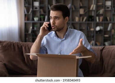 Unhappy angry Caucasian male client or buyer talk with customer service on cellphone frustrated by delivery mistake or error. Mad man have fight with shipping company dissatisfied with bad service.
