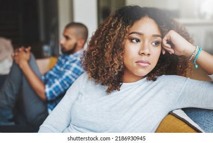 Unhappy, angry and stressed couple sitting on a sofa together after arguing. Young african american man and woman looking annoyed and ready for divorce while experiencing relationship problems - Shutterstock ID 2186930945