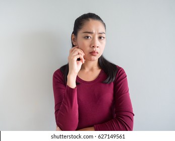 Unhappy And Annoyed Face Of Asian Woman Standing.