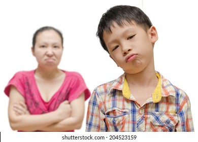 Unhappy Asian Boy With Angry Mother On  White Background