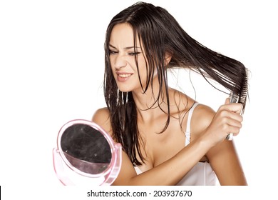 Unhappy Beautiful Young Woman Comb Her Wet Hair