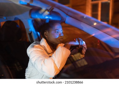 Unhappy Black Woman With Family Crisis And Conflicts Sit Alone In Car Late At Night Doesn't Want To Go Home, Meet Husband Cheater. Frustrated African American Woman Thoughtful Lying On Steering Wheel