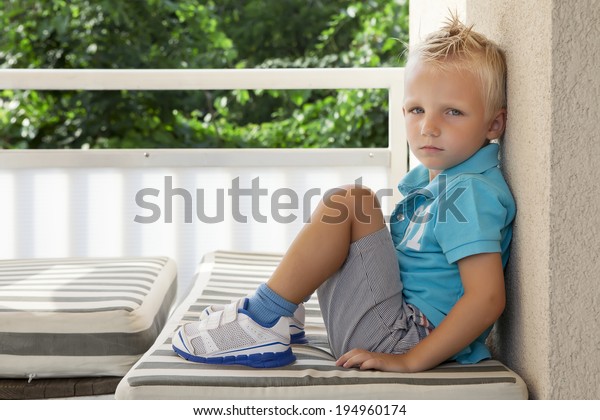 Unhappy Boy Sitting On Balcony Stock Photo 194960174 | Shutterstock