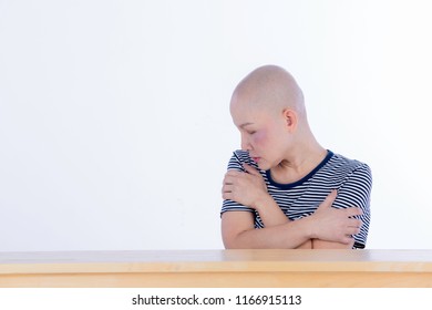 Unhappy Cancer Woman No Hair Hug Herself Feel Hopeless, Depressed, Lonely, And Suffer The Effect. Of The Unsuccessful Chemotherapeutic On Isolated Background With Copy Space